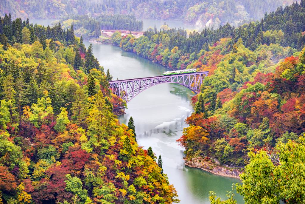 JR Tadami Line Train run on the Bridge across Tadami River, Mishima, Fukushima in Autumn
