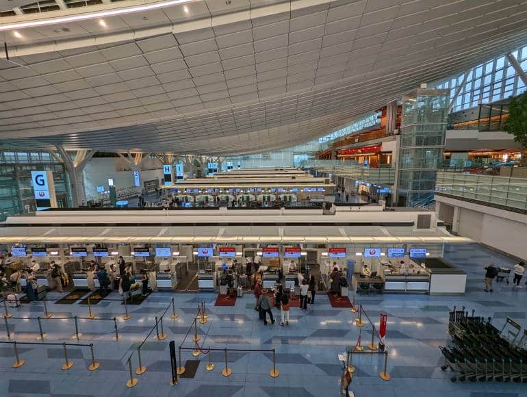 Elevated view of airline check-in counters at airport in Tokyo